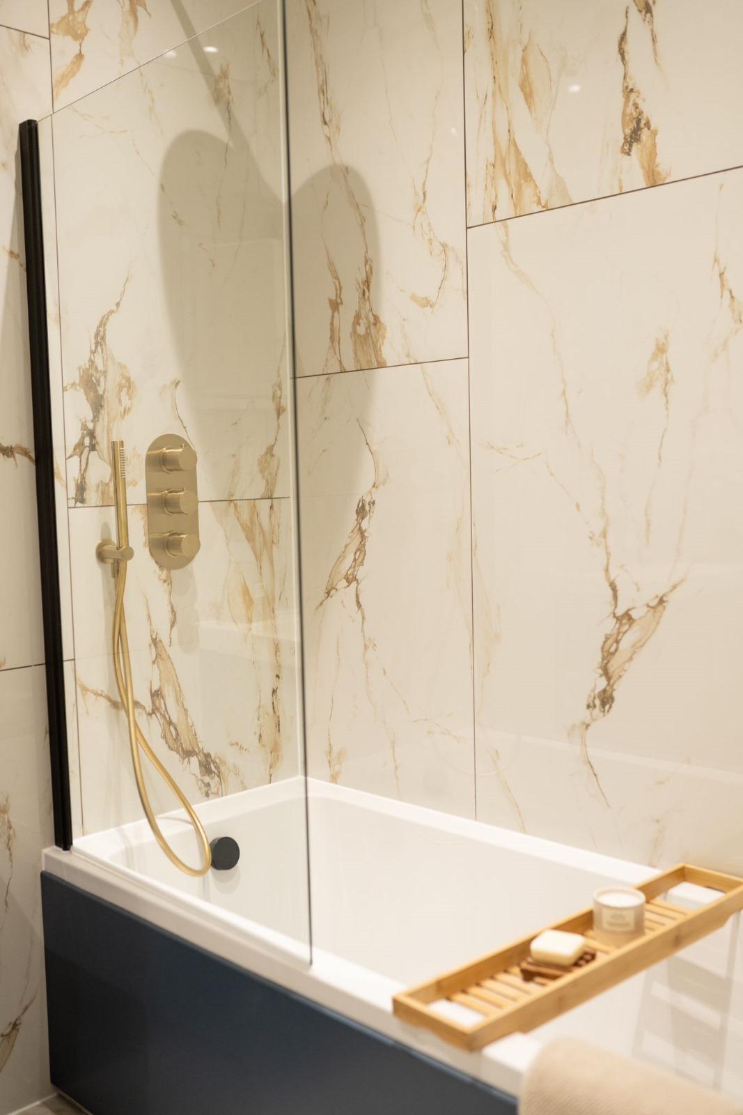 Marble bath surround with brushed brass fittings — Hawkins Factory