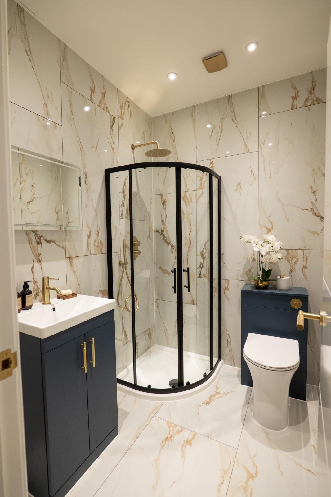 En-suite shower room with marble and brass detailing