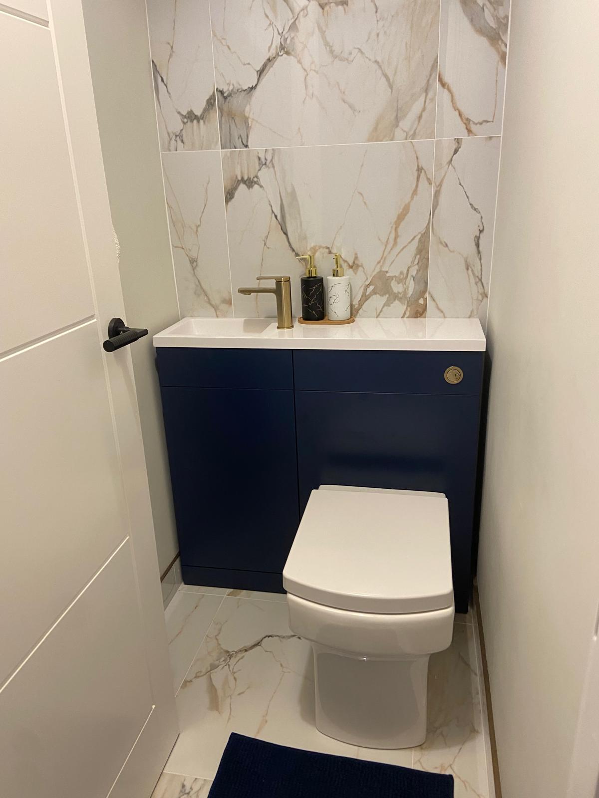 Compact navy WC unit with marble splashback